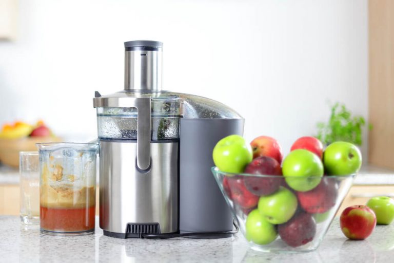 Juicing machine and different kinds of apple ready for juicing.